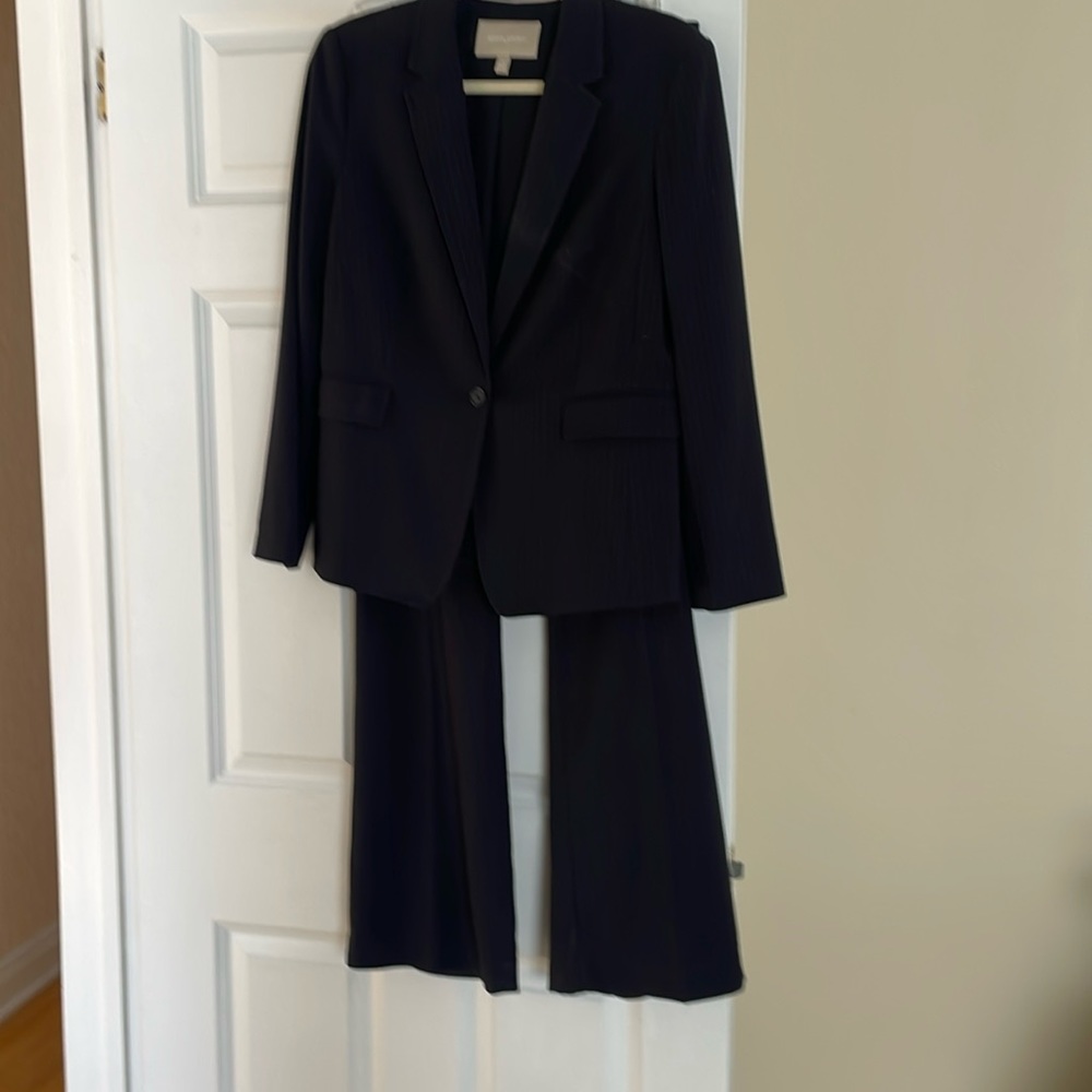 Women’s navy pinstripe suit. Blazer and pants fully lined. Worn once. Size12